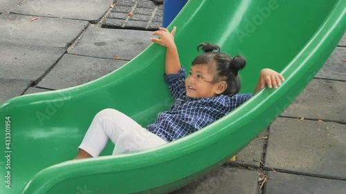 A kid adorable are playing at the playground, kids having fun playing sliding, activities kids, enjoy and leaning outdoor of kids concept, slow motion concept.