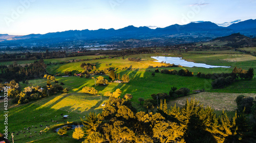 aerial landscape of mountains and lake at sunset