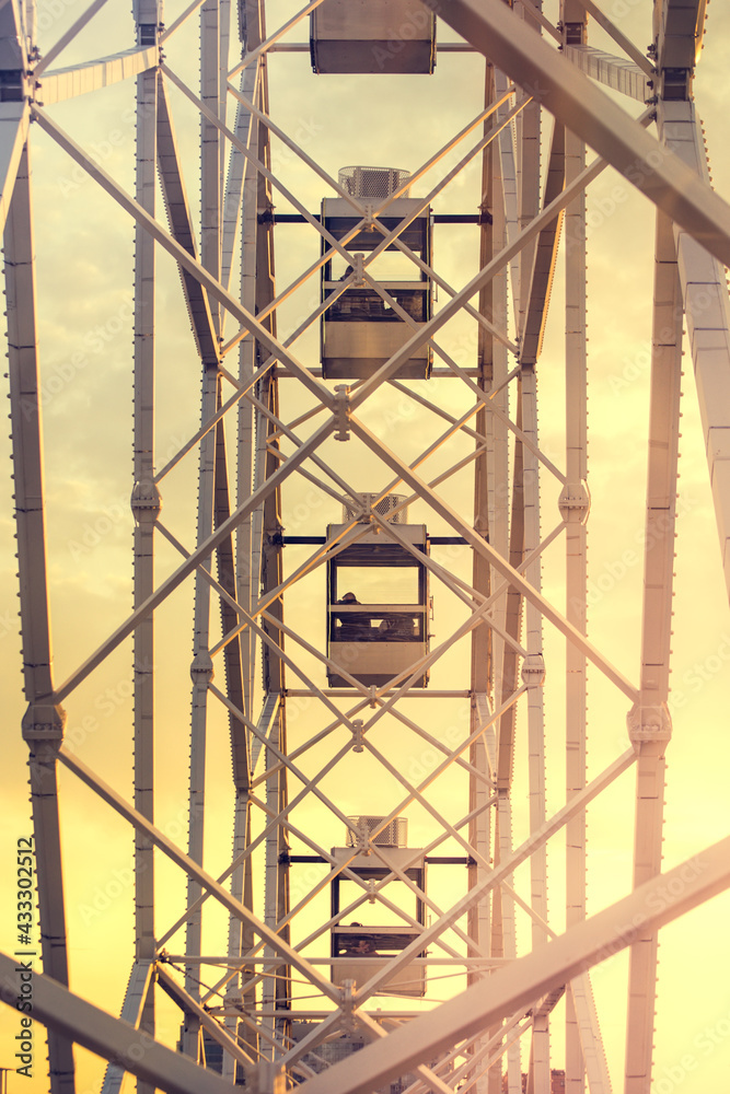 Ferris wheel, side view. Ferris wheel booths against the sky. Ferris wheel, view from the booth Ferris wheel, side view. Ferris wheel booths against the sky. Ferris wheel, view from the booth