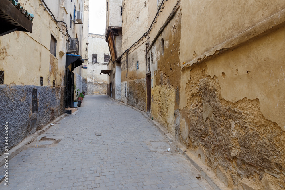 Ancient old and narrow street in the medina of Fez. Morocco.