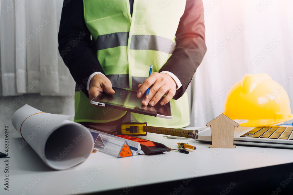 Engineers or architects is watching on model building and blueprint in working site.Construction and structure concept. Engineers or architects is watching on model building and blueprint in working site.Construction and structure concept.