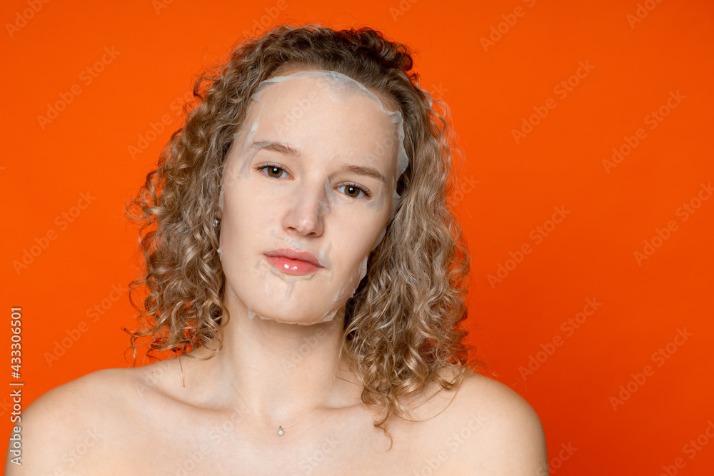 Skin care, cosmetology care. A girl without emotion, a cosmetic mask on her face Skin care, cosmetology care. A girl without emotion, a cosmetic mask on her face