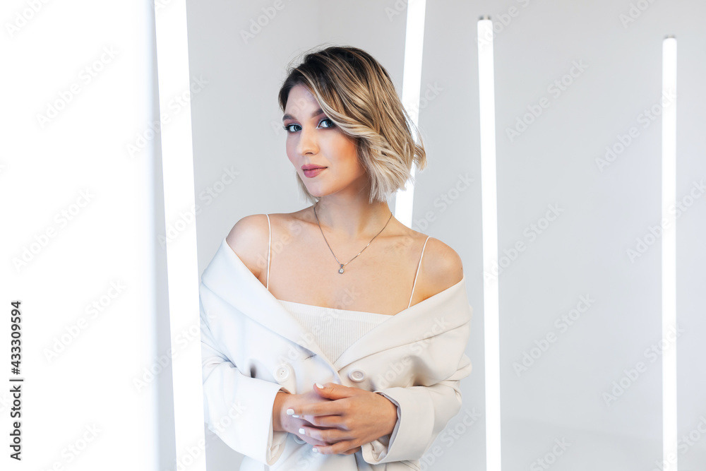 singer posing in the studio. Around the girl neon lamps singer posing in the studio. Around the girl neon lamps
