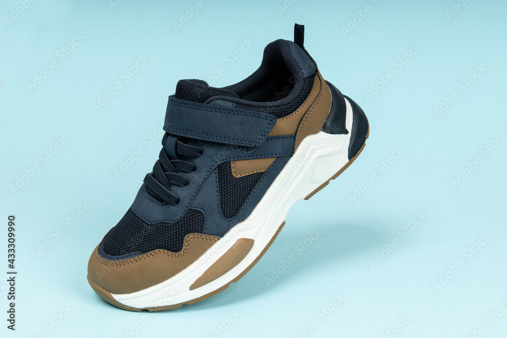 Running sports shoe on blue background. Running shoe, sneaker or trainer. Athletic shoe. fitness, sport, training concept. Running sports shoe on blue background. Running shoe, sneaker or trainer. Athletic shoe. fitness, sport, training concept.