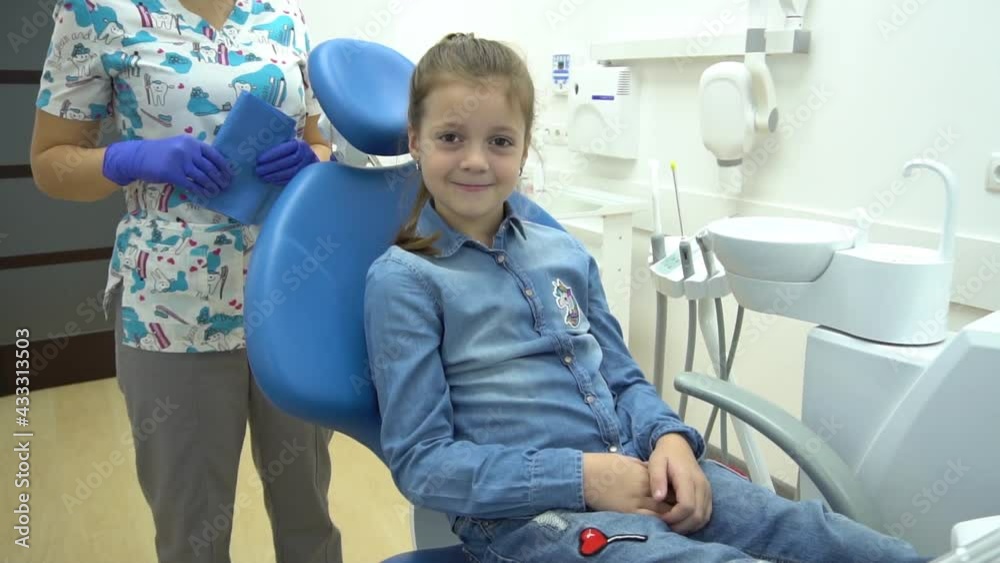 Slow Motion A portrait of a child patient in a dental chair in a dentist’s Slow Motion A portrait of a child patient in a dental chair in a dentist’s