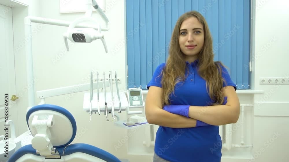 Slow Motion Portrait of female dentist. She standing at her office and she has b Slow Motion Portrait of female dentist. She standing at her office and she has b
