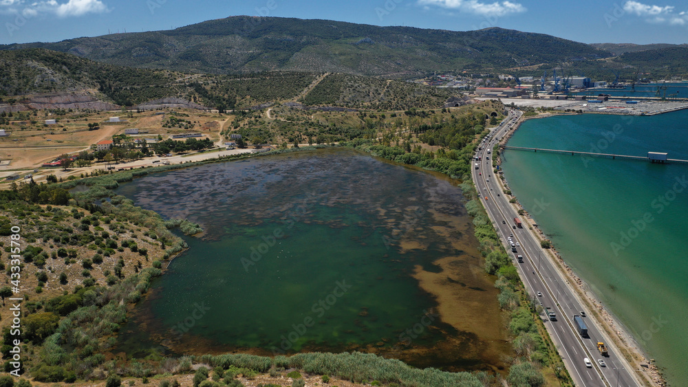 Aerial drone photo of small lake of Koumoundourou in industrial area of Aspropirgos, Attica, Greece