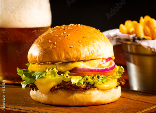 Fries, burger with a lot of cheese and bear.
