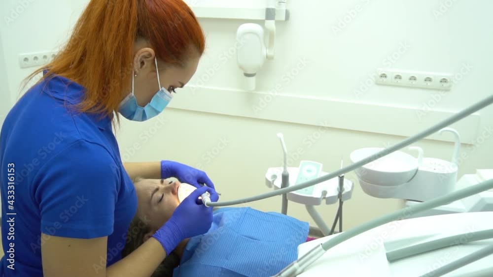 Dentist Examine Patient With Braces In Denal Clinic. Close Up Dentist Examine Patient With Braces In Denal Clinic. Close Up