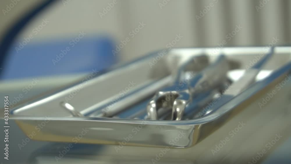 Slow Motion Metallic dentist tools close up on a dentist chair in Dentist Clinic Slow Motion Metallic dentist tools close up on a dentist chair in Dentist Clinic