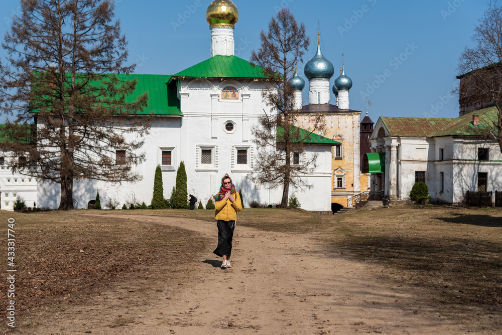 Woman, pilgrim, tourist on the territory of an ancient Orthodox Christian monastery