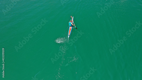 Aerial drone top down photo of young athletes competing in sport canoe in emerald lake © aerial-drone