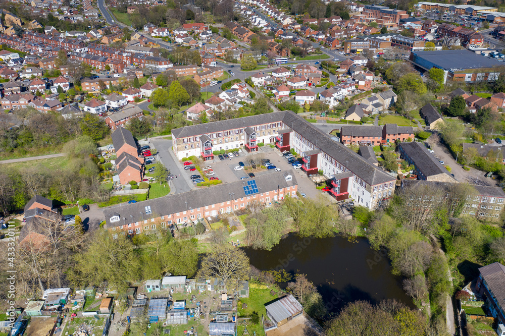 Aerial photo of the British town of Meanwood in Leeds West Yorkshire showing typical UK housing estates and rows of houses from above in the spring time on a sunny day