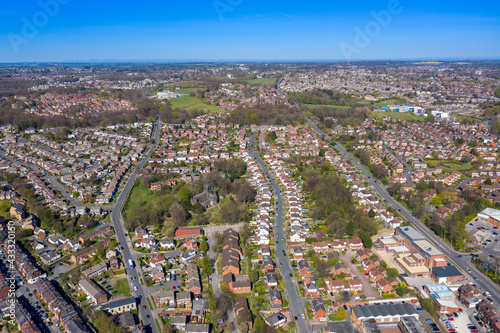 Aerial photo of the British town of Meanwood in Leeds West Yorkshire showing typical UK housing estates and rows of houses from above in the spring time on a sunny day