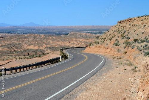 The lonely, curved rural desert road on the outskirts of Logandale Clark County Nevada. photo