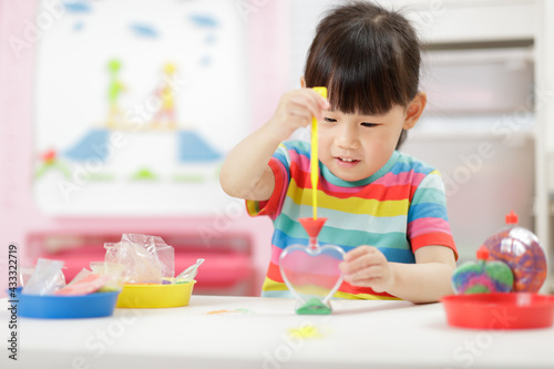 young girl making sand crafts for home schooling