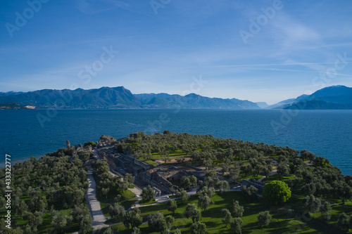 Aerial view of the Grotte di Catullo ruins of a large Roman villa on the peninsula. Lake Garda  Italy. Olive grove and archaeological museum. The grottoes at the very peak of the Sirmione peninsula.