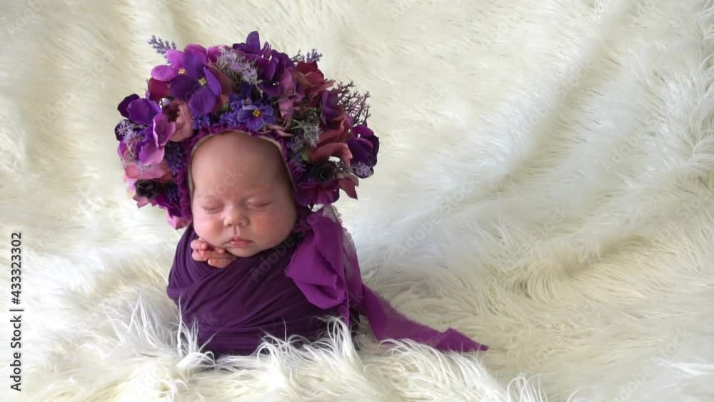 Slow Motion A newborn girl in a hat of white flowers Slow Motion A newborn girl in a hat of white flowers
