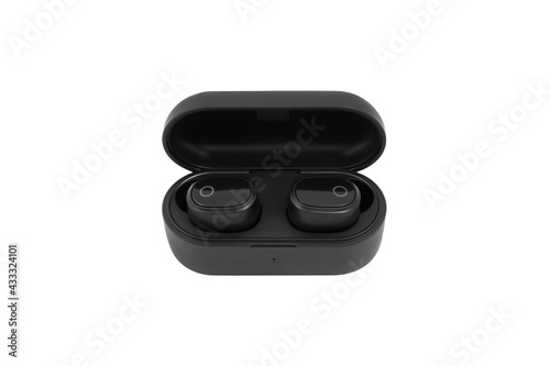Modern black wireless earbuds headphones lying in charge case isolated on white background. 
