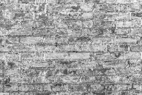 old brick wall painted with white with color peeling