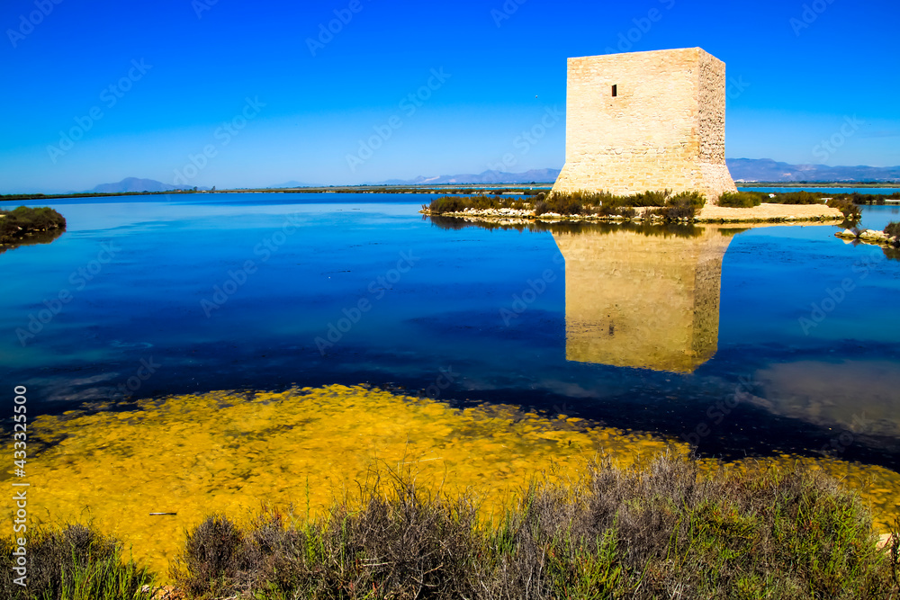 Tamarit tower surrounded by salt lagoons in Santa Pola