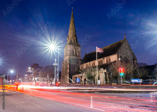 Wigan, UK, Feb 13 2021: A long exposure photograph documenting St Peter's Church, Hindley, during rush hour photo