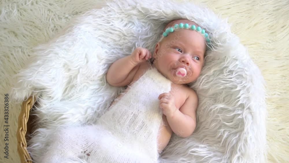 Slow Motion Cute newborn baby sleeping in wicker basket, top view Slow Motion Cute newborn baby sleeping in wicker basket, top view