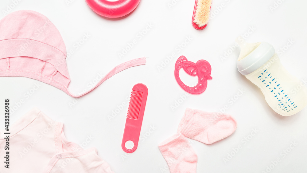 Obraz premium Clothes and accessories for newborn. Shirt, socks, toy, bottle, teether, comb. babies feeding with breast milk or infant formula powdered baby milk and toys.