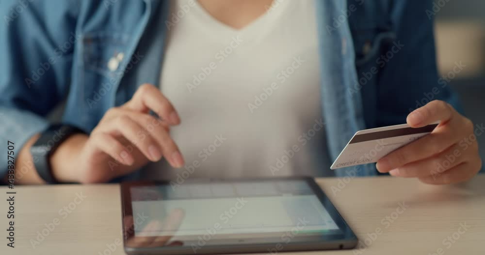 Young asia lady using tablet order online shopping product and paying bills with credit card in living room interior. Stay at house, Self quarantine activity, Fun activity for coronavirus prevention. Young asia lady using tablet order online shopping product and paying bills with credit card in living room interior. Stay at house, Self quarantine activity, Fun activity for coronavirus prevention.