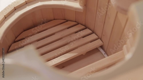 Closeup of interior of cedar phytobarrel with wooden grates for feet and sitting
