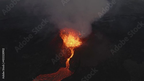 Magma spurts from crater fissure of erupting volcano, Iceland. Aerial static view  photo