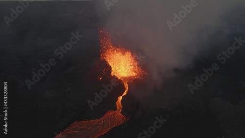 Lava fountain and magma escaping from volcano crater, Iceland. Aerial backward photo