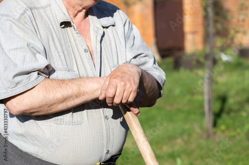 Senior Man Hands holding a garden tool