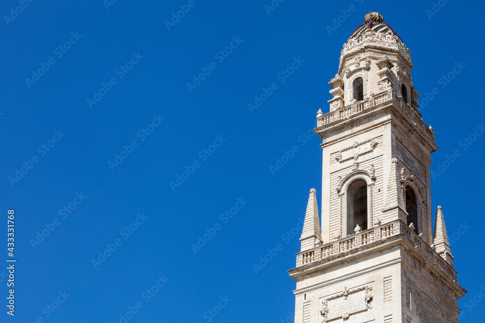 Ancient tower in the historic center of Lecce, southern Italy. Historic tower with blue sky in the background. Town center of Lecce.