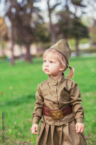 Adorable baby girl in Soviet military uniform 