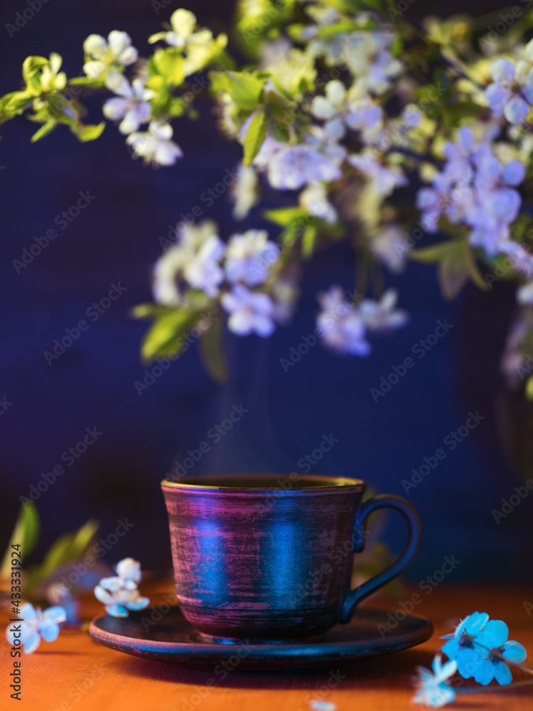 Colorful bright spring still life, a cup of espresso coffee on a wooden table, blooming branches of white cherry trees. Color light Colorful bright spring still life, a cup of espresso coffee on a wooden table, blooming branches of white cherry trees. Color light