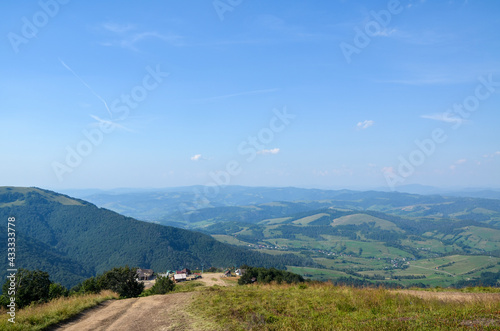 Scenic view to upper cable car station in village Pylypets from Gymba Mountain. Beautiful panorama of Carpathian Mountains on background. Ukraine
