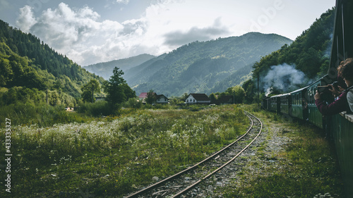 The romanian mocanita steem train going through the green mountains