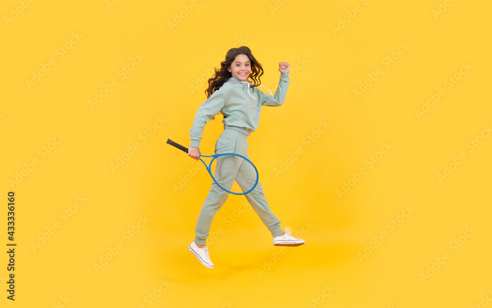 happy energetic teen girl jump in sportswear with badminton racket running to success, hurry up.