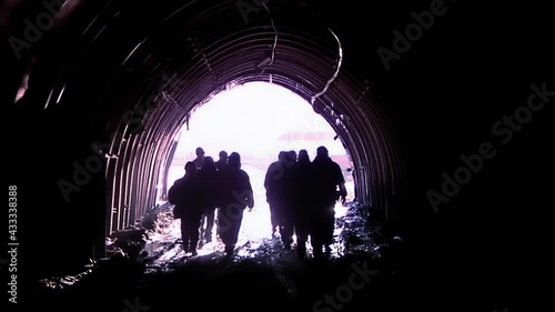 Silhouette of Miners leaving Coal Mine in Patagonia, Argentina. Slow Motion.  photo