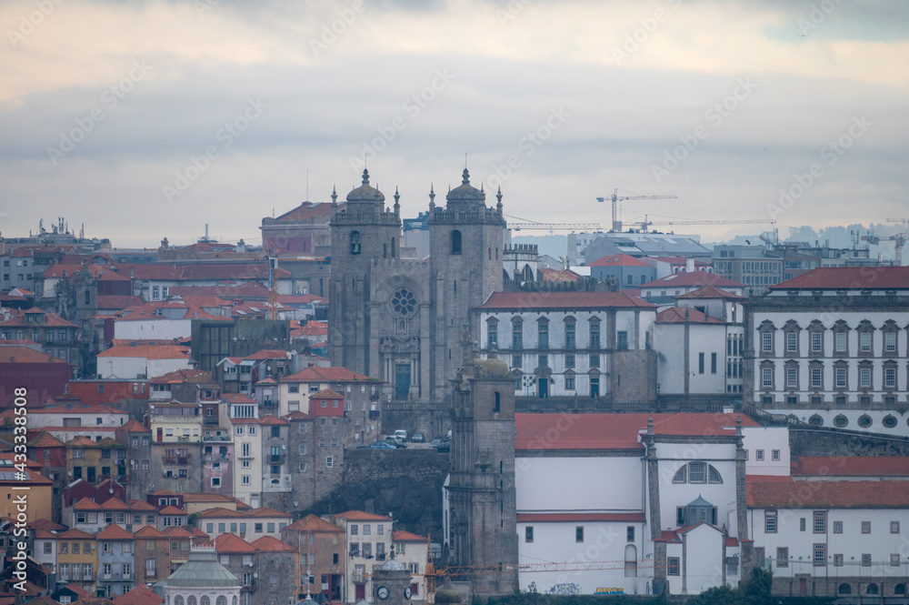 Panoramic view on Douro river and old part of Porto city in Portugal at cloudy sunrise