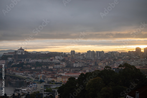 Panoramic view on Douro river and old part of Porto city in Portugal at cloudy sunrise © barmalini