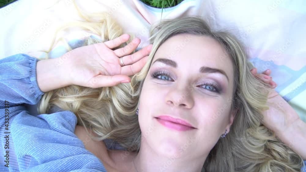 Slow Motion Beautiful Girl Lying on the Meadow and Dreaming. Enjoy Nature. Blink Slow Motion Beautiful Girl Lying on the Meadow and Dreaming. Enjoy Nature. Blink