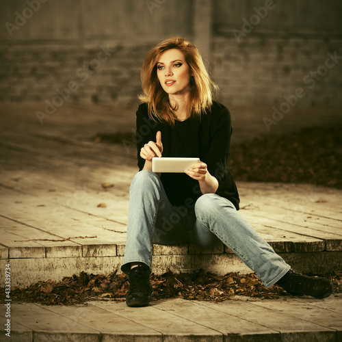 Young fashion blonde business woman using tablet computer