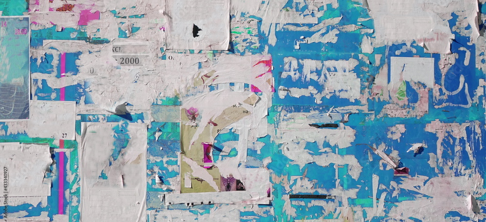 Naklejka premium Artistic Urban Street Background with Grungy Wall with Ripped, Torn And Peeled Posters. Old Wall with Scratched Advertising. Old Billboard with Torn Posters. Vintage Wide Background and Texture.