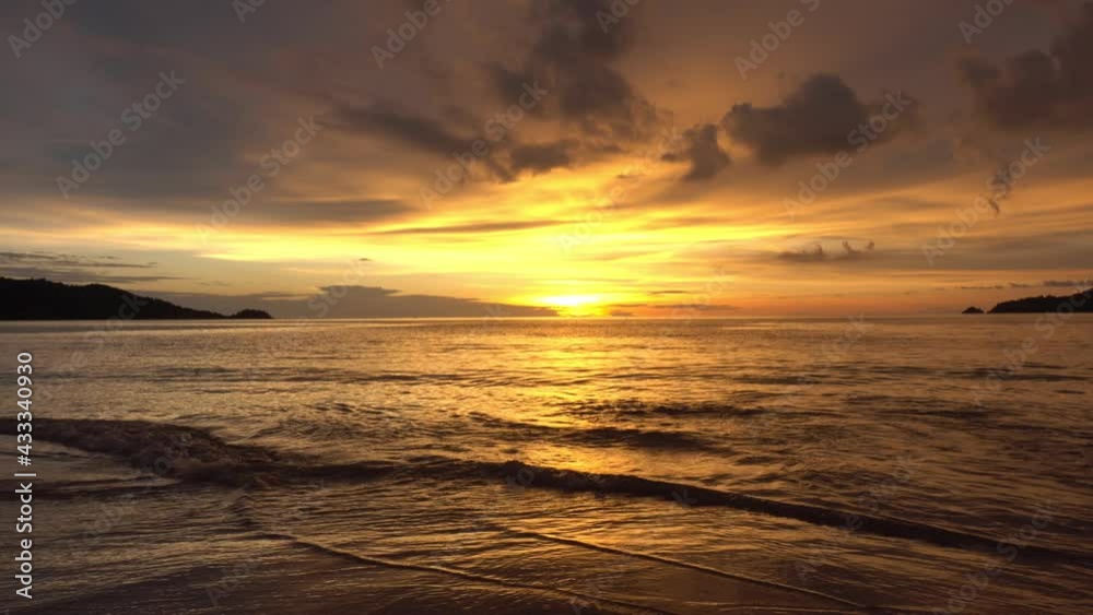 Dramatic sea sunset or sunrise Burning golden sky and shining golden waves Beautiful light reflection on sea surface Amazing landscape or seascape 4-K Nature footage Dramatic sea sunset or sunrise Burning golden sky and shining golden waves Beautiful light reflection on sea surface Amazing landscape or seascape 4-K Nature footage