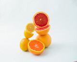 Cut citrus mix fruit on the white background. Summer fresh food concept.