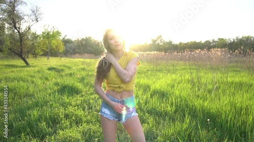 Slow Motion Happy girl enjoying the sun in a meadow in a summer sunny day