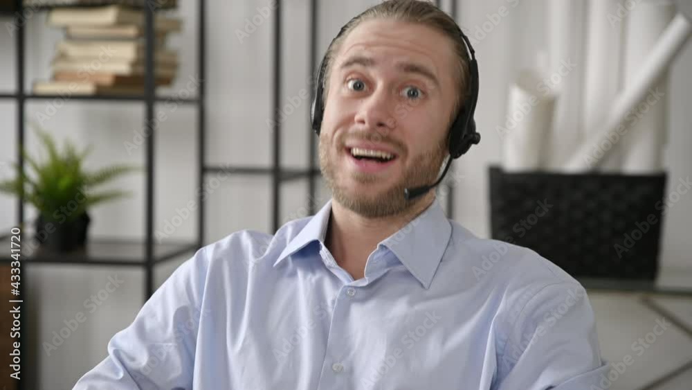 Charismatic friendly american satisfied man, operator of call center, business leader, expert, tutor in headset and formal shirt talking by video conference with colleague,conducts online consultation