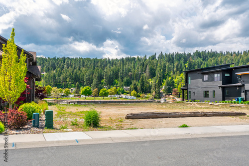 An empty vacant lot between two luxury riverfront homes in the city of Coeur d'Alene, Idaho, USA